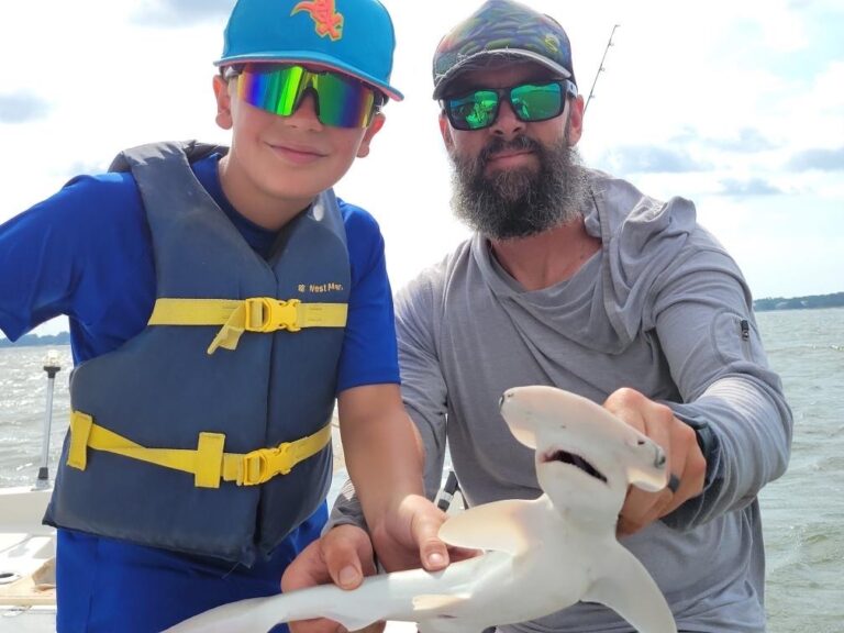 family shark fishing a boy catches his first shark with captain Heath